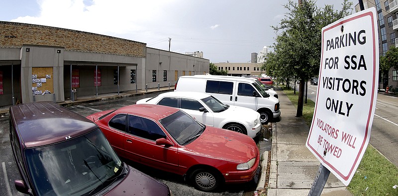 A parking sign for the former Social Security Administration office is seen in Houston, Wednesday. Budget cuts have forced the Social Security Administration to close dozens of field offices even as millions of baby boomers approach retirement, swamping the agency with applications for benefits, a senior agency official told Congress Wednesday.