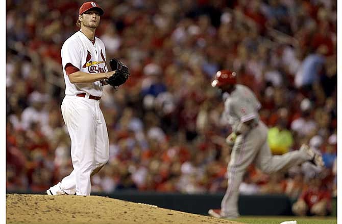 Philadelphia Phillies' Ryan Howard, right, rounds the bases after hitting a two-run home run off St. Louis Cardinals starting pitcher Shelby Miller, left, during the sixth inning of a baseball game on Thursday, June 19, 2014, in St. Louis.