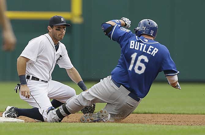 Kansas City Royals designated hitter Billy Butler beats the tag of Detroit Tigers second baseman Ian Kinsler for a double during the sixth inning of a baseball game in Detroit, Thursday, June 19, 2014.