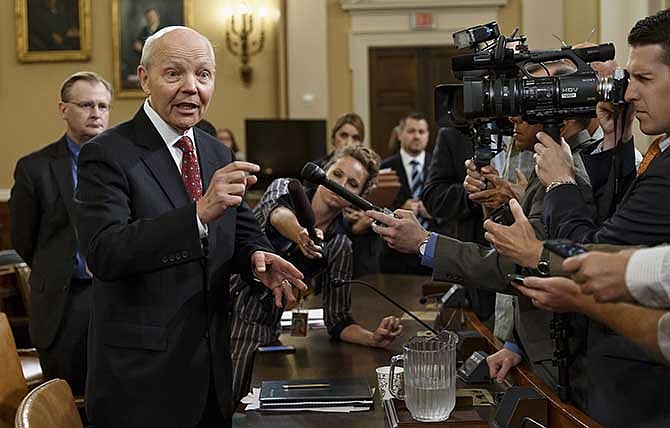 Internal Revenue Service Commissioner John Koskinen talks to reporters during a break in his appearance before the House Ways and Means Committee hearing on their continuing probe of whether tea party groups were improperly targeted for increased scrutiny by the IRS, Friday, June 20, 2014, on Capitol Hill in Washington. 