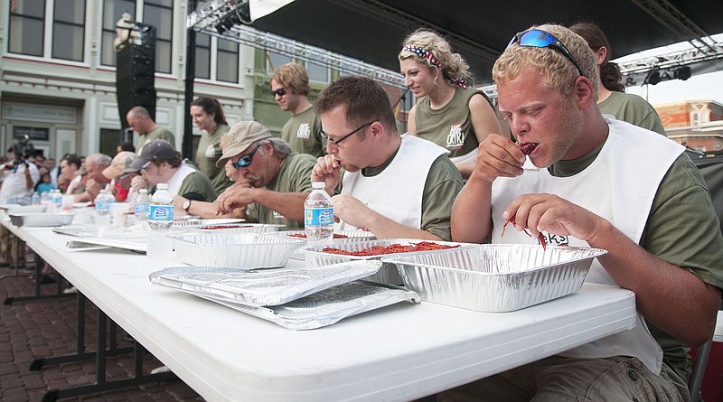 Ten contestants in the Fulton Street Fair "Hit the Crik" crawfish eating contest take their first bites Friday.
