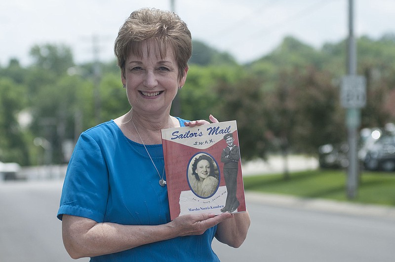 Marsha Norris Knudsen of Columbia poses for a photo holding her recently published book, "Sailor's Mail," which tells the love story of her parents during World War II.