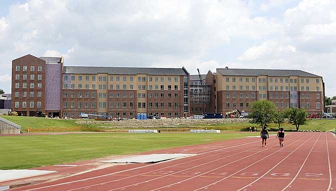 In this June, 10, 2014 photo is Shocker Hall, the new dormitory at Wichita State University, that is nearing completion in Wichita, Ks. WSU and other universities across the nation are in the midst of a campus housing boom, replacing aging residence halls and student unions with gleaming facilities whose technology and other comforts are aimed at attracting students who demand more from college life. (AP Photo/The Wichita Eagle, Jaime Green)