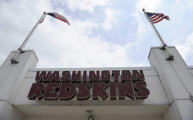 In this June 18, 2014 file photo, the Washington Redskins name is displayed on a building at their training facility at Redskins Park during NFL football minicamp in Ashburn, Va. Based on testimony from linguistics and lexicography experts, and a review of how the term was used in dictionaries, books, newspapers, magazines and movies, the Trademark Trial and Appeal Board ruled 2-1 that the "Redskins" was disparaging to Native Americans on Wednesday, June 18, 2014.