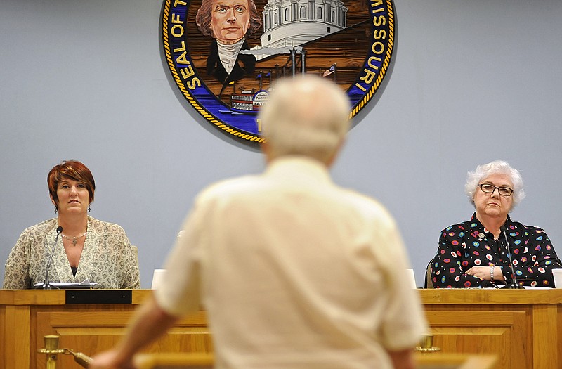 City Council Ward 2 candidates Laura Ward, left, and Carolyn McDowell, right, listen as Jefferson City resident Paul Van Horn steps up to ask where each sees the city in 15 years during an open house and public forum at City Hall on Monday afternoon.