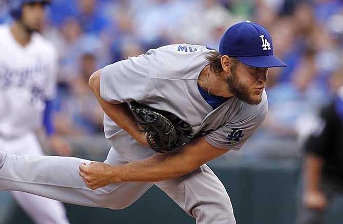 Los Angeles Dodgers pitcher Clayton Kershaw throws to a batter in the first inning of a baseball game against the Kansas City Royals at Kauffman Stadium in Kansas City, Mo., Tuesday, June 24, 2014. 