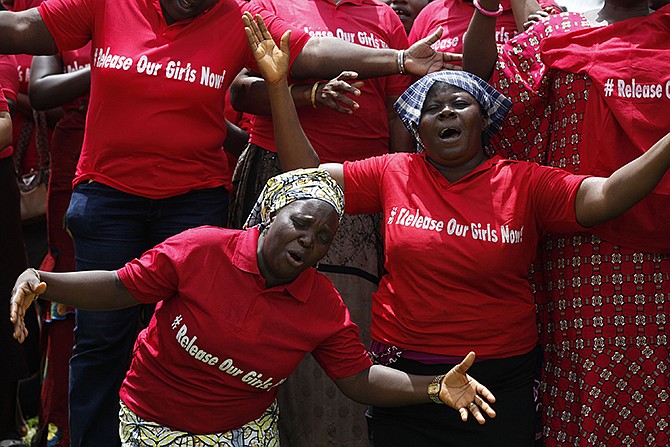 Women attend a prayer meeting calling on the government to rescue the kidnapped girls of the government secondary school in Chibok, in Abuja, Nigeria. Extremists have abducted 91 more people, including toddlers as young as 3, in weekend attacks on villages in Nigeria.