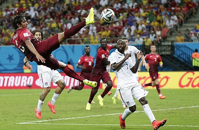 In this June 22, 2014 file photo, Portugal's Bruno Alves kicks the ball above United States' DaMarcus Beasley, lower right, during the group G World Cup soccer match between the United States and Portugal at the Arena da Amazonia in Manaus, Brazil. For U.S. fans without cable television, there are more apps and options than ever to watch "the beautiful game."