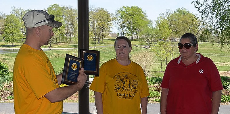 Assistant Cubmaster Brad Friedmeyer presents special recognition plaques Webelos 2 Den Leaders Barbara Riggs and Rose Blair.