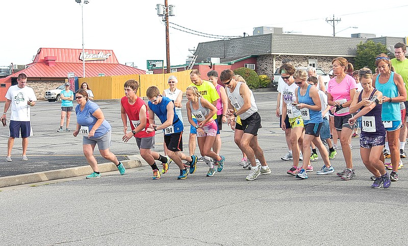 The runners come off the mark at the MCMC 5k Walk / Run which began at Village Green ShoppingCenter Saturday, June 21.