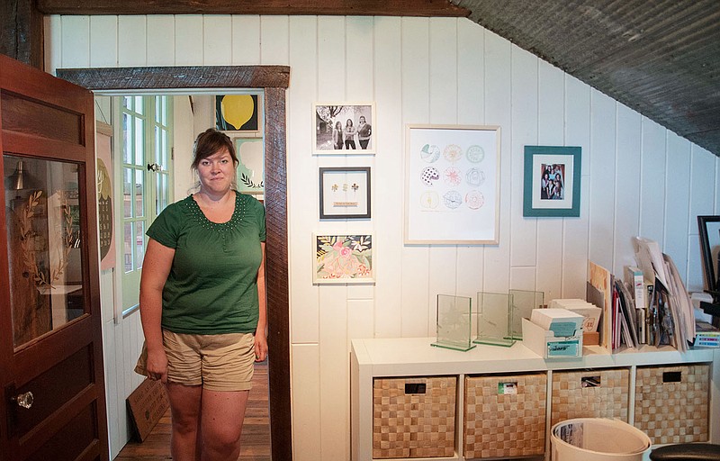 Beth Snyder, co-partner of the letterpress company 1canoe2, stands in her office for a photo Thursday. Snyder entered the business with her childhood friend Carrie Shyrock and Shyrock's sister-in-law Karen Shyrock in 2009.
