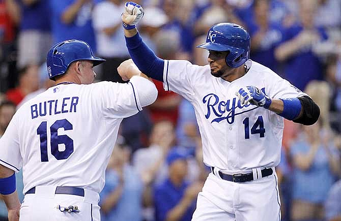 Kansas City Royals' Omar Infante (14) celebrates with Billy Butler (16) after hitting a grand slam home run in the third inning of a baseball game against the Los Angeles Angels at Kauffman Stadium in Kansas City, Mo., Friday, June 27, 2014.