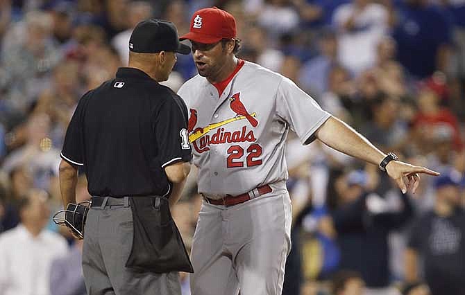 St. Louis Cardinals manager Mike Matheny, right, talks with home plate umpire Vic Carapazza after Cardinals' Jon Jay was called out at home plate during the seventh inning of a baseball game against the Los Angeles Dodgers, Thursday, June 26, 2014, in Los Angeles. The play was reviewed and the call stood.