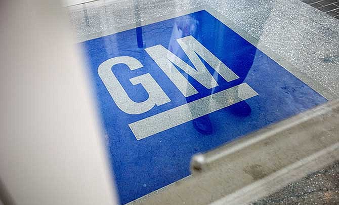  In this Thursday, Jan. 10, 2013 file photo, the logo for General Motors decorates the entrance at the site of a GM information technology center in Roswell, Ga. 