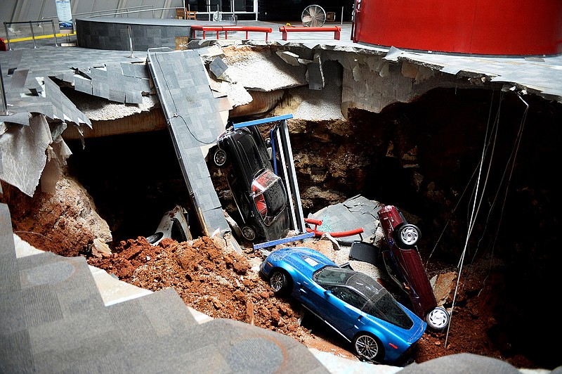 Cars lie in a sinkhole that opened up at the Skydome showroom in the National Corvette Museum in Bowling Green, Kentucky. The board of the museum in Kentucky voted Wednesday to preserve a large section of the sinkhole that opened beneath the museum in February.