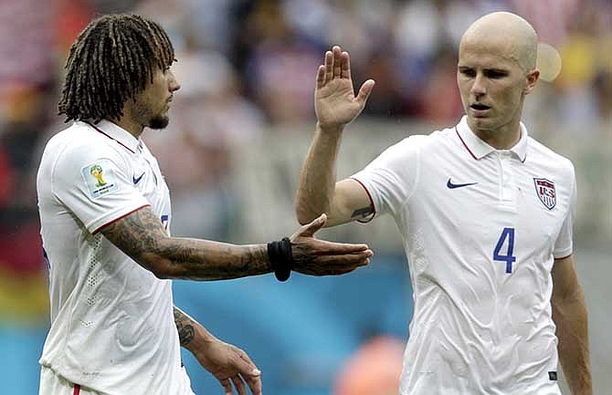United States' Michael Bradley, right, congratulates his teammate Jermaine Jones after qualifying for the next World Cup round following their 1-0 loss to Germany during the group G World Cup soccer match between the USA and Germany at the Arena Pernambuco in Recife, Brazil, Thursday, June 26, 2014.