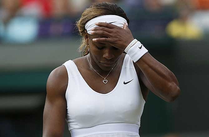 Serena Williams of U.S. gestures after losing a point to Alize Cornet of France during their women's singles match at the All England Lawn Tennis Championships in Wimbledon, London, Saturday, June 28, 2014.