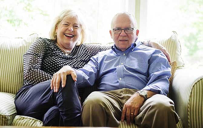 In this photo taken on June 3, 2014, Patsy and David Dalton pose for a photo in their home in Columbia, Mo. Dalton were married for 10 years before a third partner entered the relationship. Twenty years later, the couple is still going strong, even with David's Parkinson's disease. (AP Photo/The Columbia Daily Tribune, Ryan Henriksen)