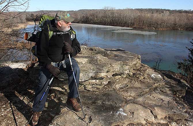 In this March 16, 2014 photo, Robert Crampton hikes around Lake Springfield in Springfield, Mo. Crampton plans to lead a group of veterans on a 261-mile trek of Missouri's Ozark Trail in October. (AP Photo/The Springfield News-Leader, Wes Johnson)