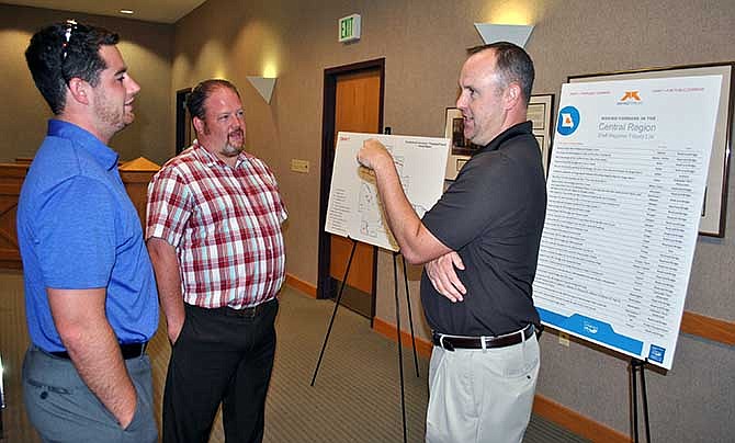 At right, Aaron Gresham, representative of Sen. Mike Kehoe's office, discusses MoDOT's central region project priority list with Lake of the Ozarks Council of Local Governments Regional Planner Andy Draper, left, and Osage Beach Public Works Director Nick Edelman at a public forum about Constitutional Amendment 7 Wednesday at Osage Beach City Hall. 