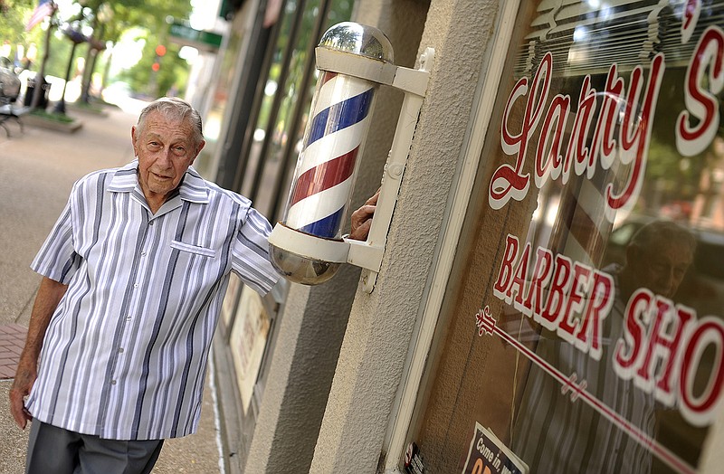 Longtime Jefferson City barber Larry Horstdaniel stands outside his Madison Street barbershop.