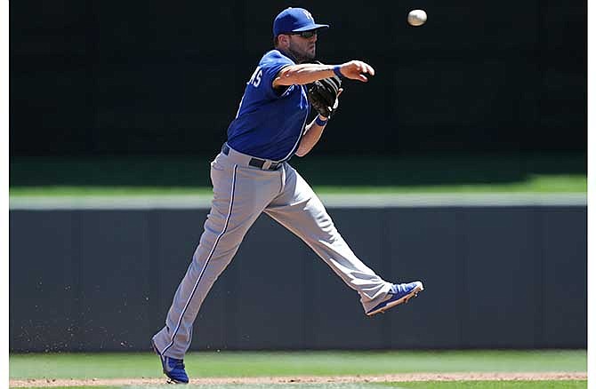 Kansas City Royals' Mike Moustakas throws out Minnesota Twins' Eric Fryer on a sharp grounder in the third inning of a baseball game, Wednesday, July 2, 2014, in Minneapolis.