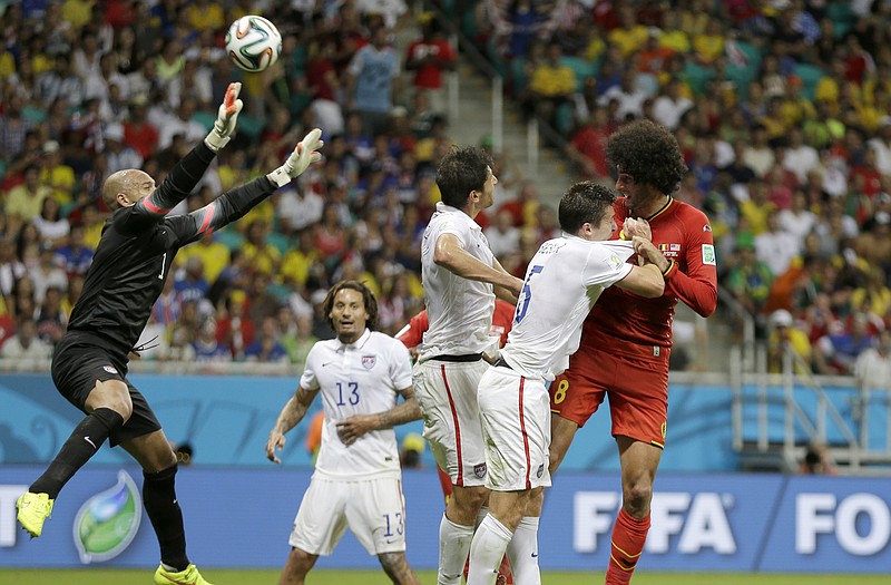 United States goalkeeper Tim Howard leaps up to stop a header by Belgium's Marouane Fellaini during Tuesday's match in Salvador, Brazil.