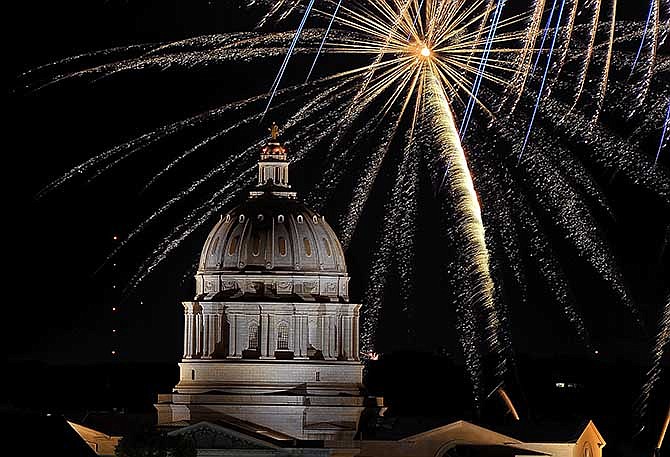 A fireworks show high over the Missouri Capitol dome caps a full day of activities on Friday, July 4, 2014, in downtown Jefferson City.