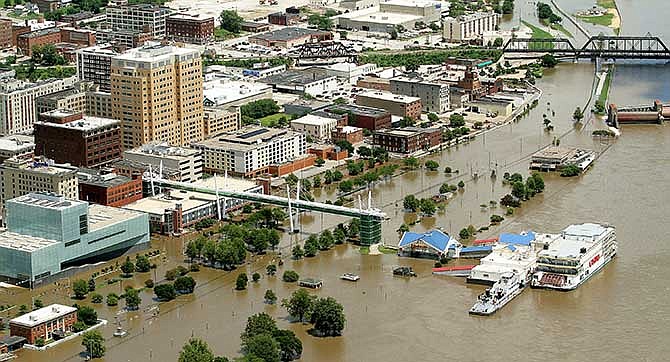 This Thursday, July 3, 2014 aerial photo shows flooding along River Drive in Davenport, Iowa as the Mississippi River approaches the crest. The National Weather Service reported that the Mississippi River crested in Davenport at 20.89 feet - well above flood stage of 15 feet but nearly two feet below the record set in 1993. (AP Photo/The Quad City Times, John Schultz) 
