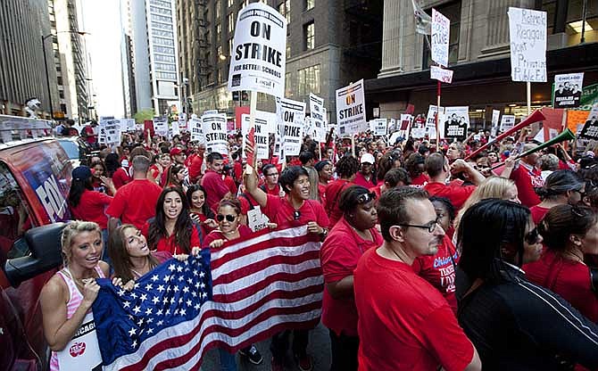 This Sept. 10, 2012, file photo shows thousands of public school teachers rallying outside the Chicago Public Schools district headquarters on the first day of strike action over teachers' contracts in Chicago. A majority of union members today now have ties to a government entity at the federal, state or local levels. The typical union worker now is more likely to be an educator, office worker or food or service industry employee rather than a construction worker, autoworker, electrician or mechanic, with far more women than men among the ranks. Overall, 11.3 percent of U.S. wage and salary workers are unionized, down from a peak of 35 percent during the mid-1950s.