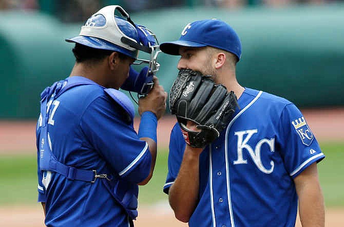 Kansas City Royals starting pitcher Danny Duffy, right, talks with catcher Salvador Perez during the sixth inning of a baseball game against the Cleveland Indians, Sunday, July 6, 2014, in Cleveland. 