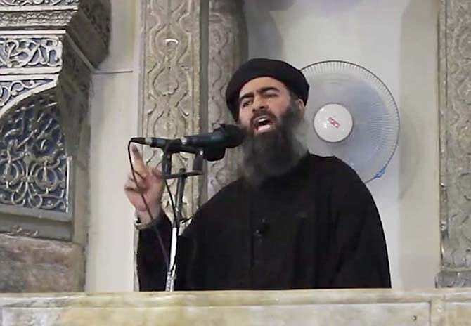 This image made from video posted on a militant website Saturday, purports to show the leader of the Islamic State group, Abu Bakr al-Baghdadi, delivering a sermon at a mosque in Iraq. 