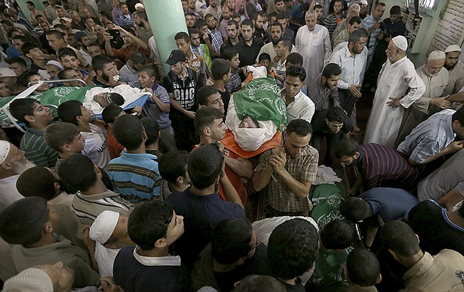 Palestinians carry bodies of the Ezz Al-Din Al Qassam Brigades members who were killed in an airstrike during a funeral in Rafah, southern Gaza Strip on Monday. The Islamic militant group Hamas that rules Gaza vowed revenge on Israel for the death of several of its members killed in an airstrike early Monday morning.