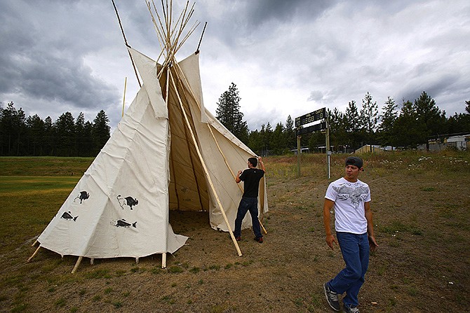 On the high school's football field, Kennedy Seyler, right, and A.J. Kieffer practice assembling a teepee for a competition in Wellpinit, Washington. 