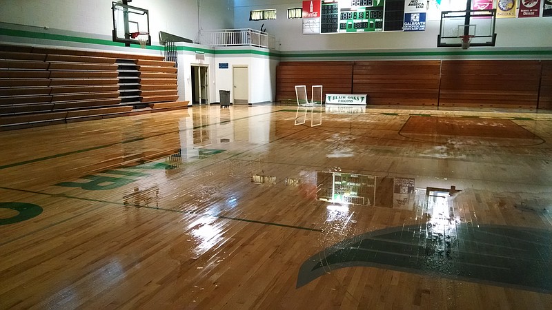 Heavy winds overnight caused significant damage at Blair Oaks High School gymnasium. A portion of the roof was blown off and heavy rains flooded the building, damaging ceiling tiles, computers, the gym's hardwood floor, etc. A crew from Servepro was on the scene drying the gym floor and vacuuming whatever water they could locate. The goal is to remove water as quickly as possible to avoid mold and mildew.
