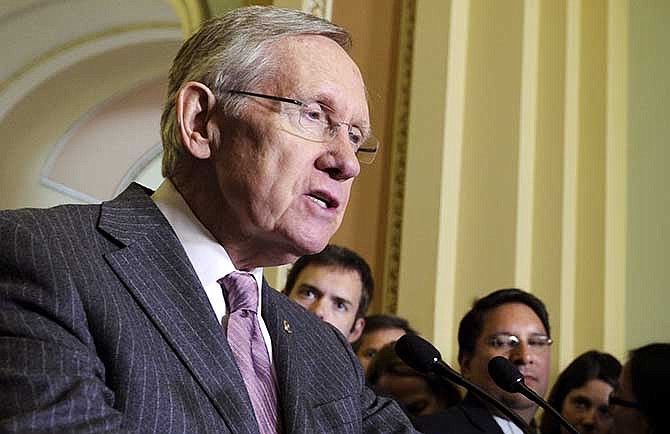 This July 8, 2014 photo shows Senate Majority Leader Harry Reid of Nev.speaks to reporters on Capitol Hill in Washington. Reid is blocking a parade of campaign-season votes on gun rights that could have been a political problem for Democrats seeking to retain control of the chamber in this fall's elections. The Nevada Democrat used Senate procedures Wednesday to prevent votes on any amendments to a bipartisan measure expanding hunters' access to public lands and renewing land conservation programs. The thwarted amendments included proposals by Republicans expanding gun owners' rights and by Democrats toughening firearms restrictions.