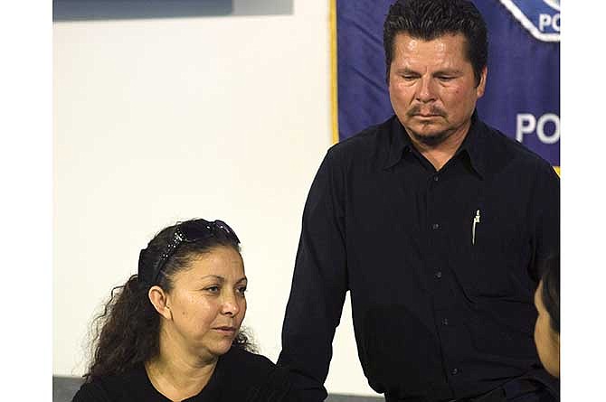 Rubi Rubio's mother Marisol Hernandez, left, and father, Pablo Rubio speak to the press at the Santa Ana Police Department Tuesday, July 8, 2014 about homicide victim Rubi Rubio during a press conference at the Santa Ana Police Department Tuesday, July 8, 2014, in Santa Ana, Calif. Rubi Rubio, 15, died of her injuries Saturday, July 5, 2014, two days after she jumped onto the speeding car of a robber who snatched her iPhone, and detectives are asking for the public's help in finding two suspects.