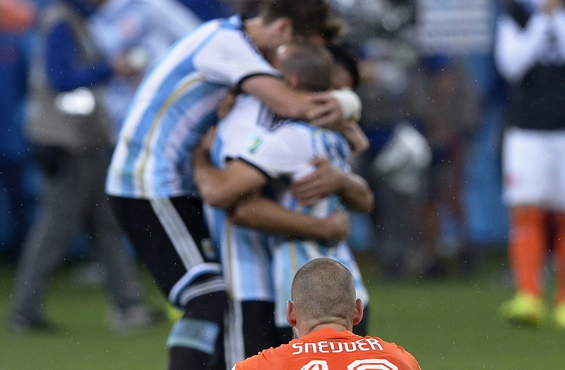 Wesley Sneijder of the Netherlands watches as Argentina players celebrate after winning in a shootout Wednesday  in Sao Paulo.