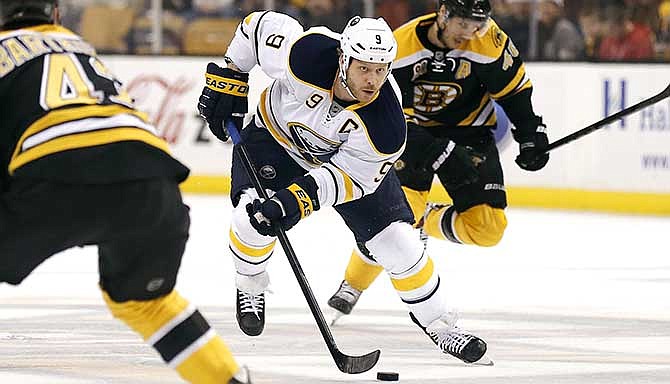 In this Dec. 21, 2013 file photo, Buffalo Sabres' Steve Ott moves the puck against the Boston Bruins in Boston. The St. Louis Blues, who acquired Ott from Buffalo, have re-signed him to a two-year contract.