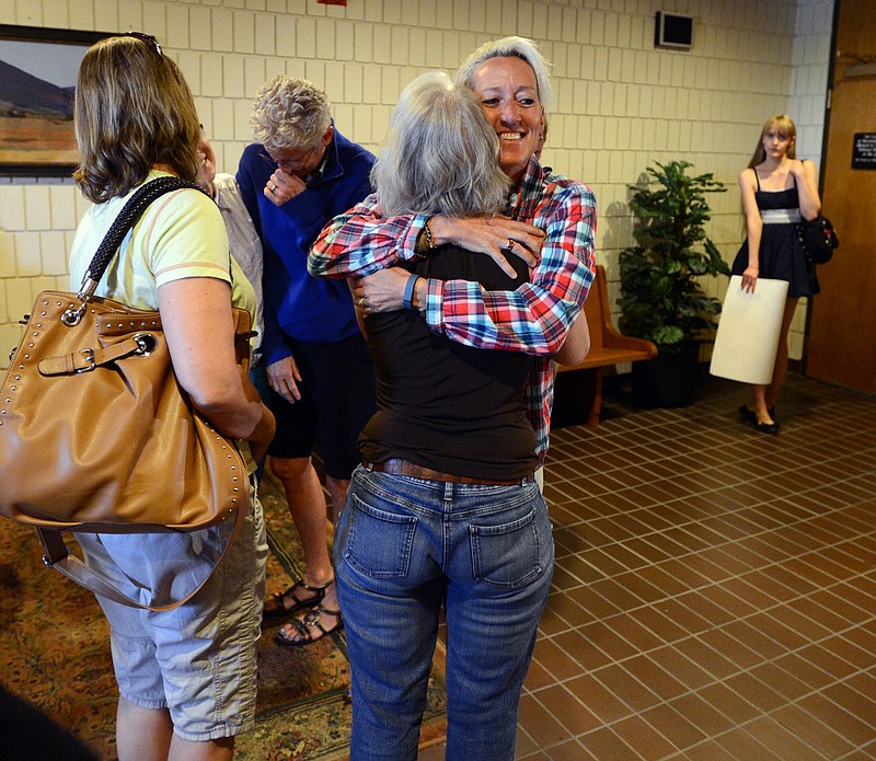 Supporters of Boulder County Clerk and Recorder Hillary Hall hug outside the courtroom at the Boulder County Justice Center on Wednesday, in Boulder, Colorado. Hall, is in court to respond to a suit brought by Colorado Attorney General John Suthers who wants the court to issue an injunction to stop the county from issuing marriage licenses to same-sex couples. 