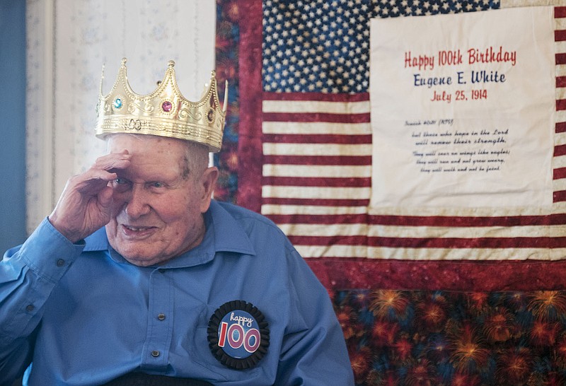 World War II veteran Eugene White, 99, of Fulton salutes back to a young boy Saturday during a birthday party celebrating his 100th birthday. He will turn 100 on July 25.