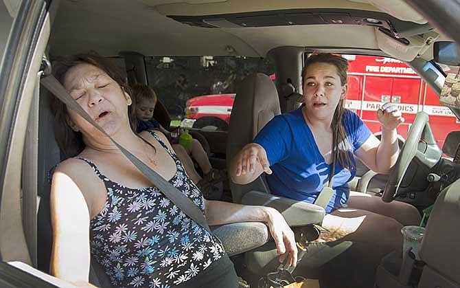 Sara Lavigne, right, and her mother, cancer patient Jana Lavigne, leave Deaconess Health and Education Center in Spokane, Wash., Tuesday after witnessing a shooting inside the Rockwood Cancer Treatment Center. Police say Christopher Henderson fatally shot his wife Sheena before fatally shooting himself inside the medical center. Police said no one else was injured in the shooting. (AP Photo/The Spokesman-Review, Colin Mulvany)