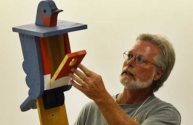 Steve Smith, of Sullivan, Mo., shows off one of the nesting boxes he made for Eastern Bluebirds during a talk at the Missouri Bluebird Society's annual conference on Saturday, July 12, 2014.