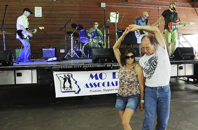 Boni Wagers, Jefferson City, and Fred Sandbothe, Westphalia, dance to the sounds of Birdseye Blues during Blue Sunday at Memorial Park. The annual event raises funds for the Missouri Blues Association's Blues in the Schools program. Both Wagers and Sandbothe are members of the Jefferson City Swing Dance Club.