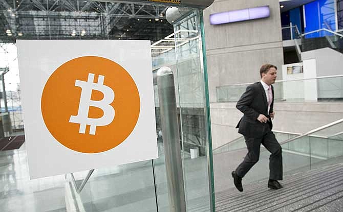 In this April 7, 2014 file photo, a man arrives for the Inside Bitcoins conference and trade show in New York. 