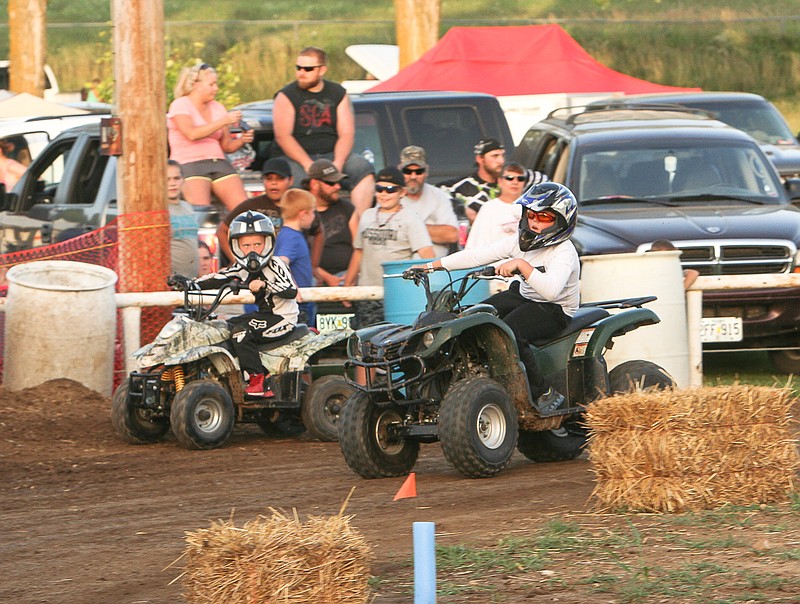 California's Preston Miller, at right, won the main event of the 50-110cc Advanced class at the Extreme 4 Wheeler Races Saturday night at the main arena at the Moniteau County Fairgrounds, California. 