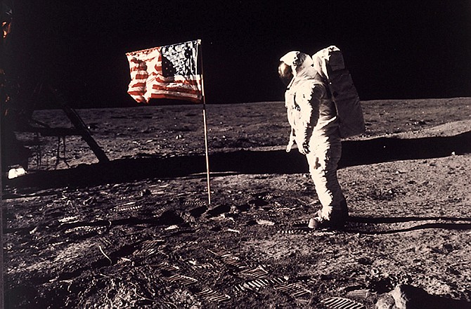 This July 20, 1969 file photo provided by NASA shows astronaut Edwin E. "Buzz" Aldrin Jr. posing for a photograph beside the U.S. flag deployed on the moon during the Apollo 11 mission. 