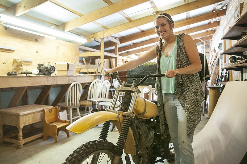 Hanna Taylor of Auxvasse stands in her storage facility filled with items for her to repurpose and sell - including a dirt bike which she said someone donated to her. 