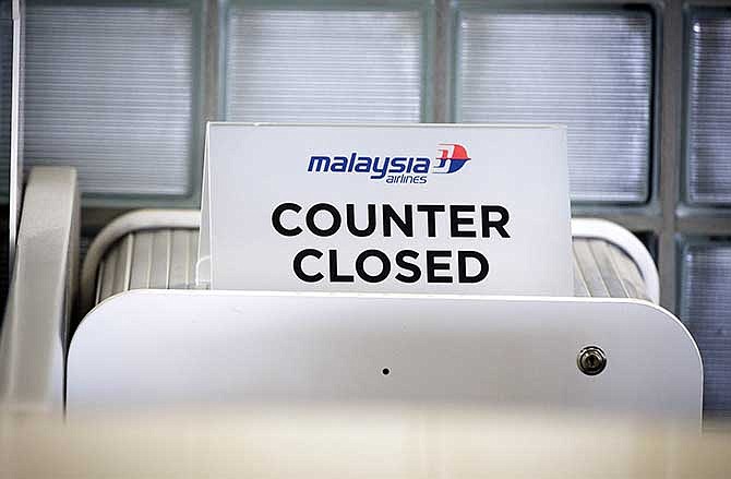 A closed desk of Malaysian airlines is seen at Schiphol airport in Amsterdam, Thursday, July 17, 2014. 