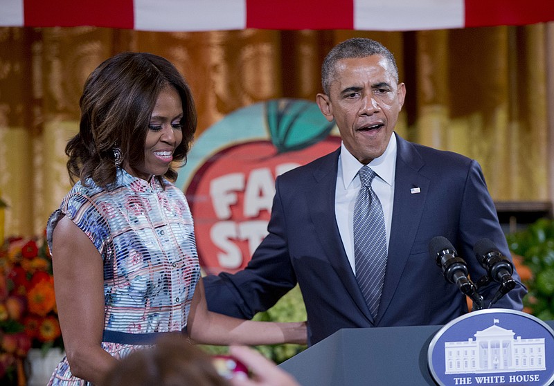 President Barack Obama joins first lady Michelle Obama, the host of the "Kids State Dinner" in the East Room of the White House in Washington, Friday. The White House treated more than 50 kid chefs to a "state dinner."